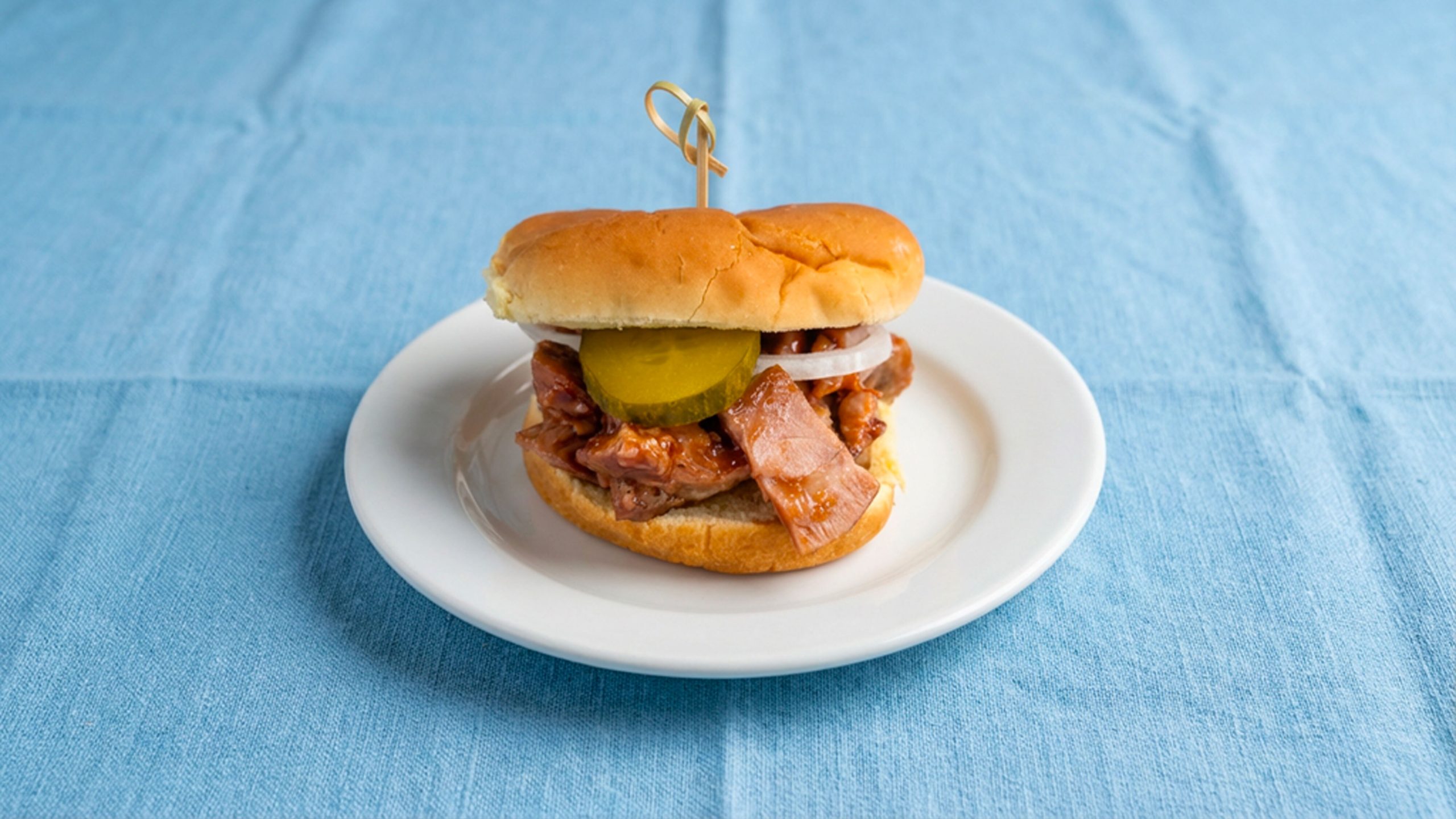 Texas style BBQ chopped turkey sandwich on a white plate